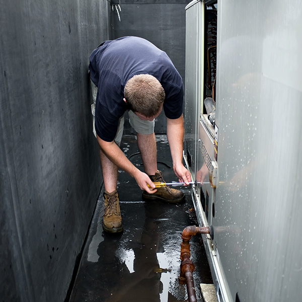 hvac technician repairing a commercial hvac unit