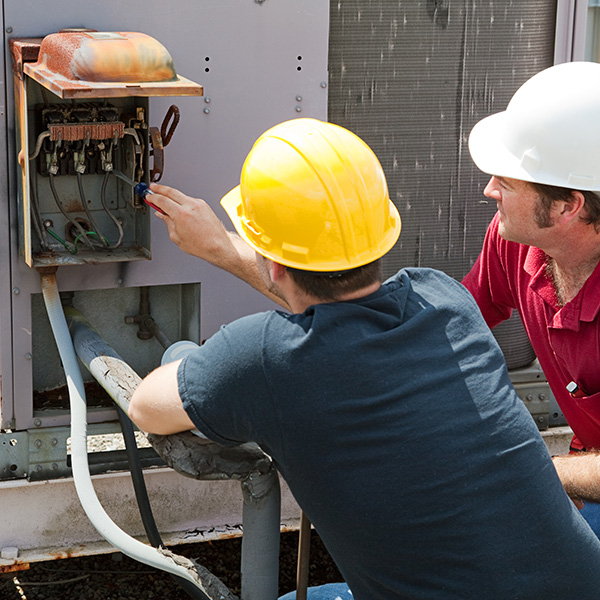 hvac technician repairing a commercial hvac unit