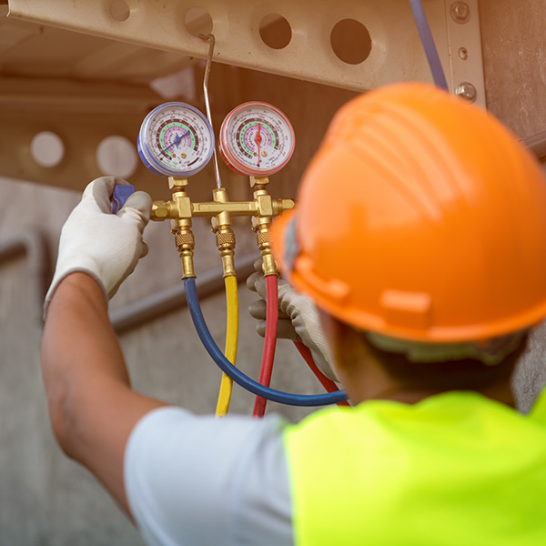 hvac technician repairing a commercial hvac unit