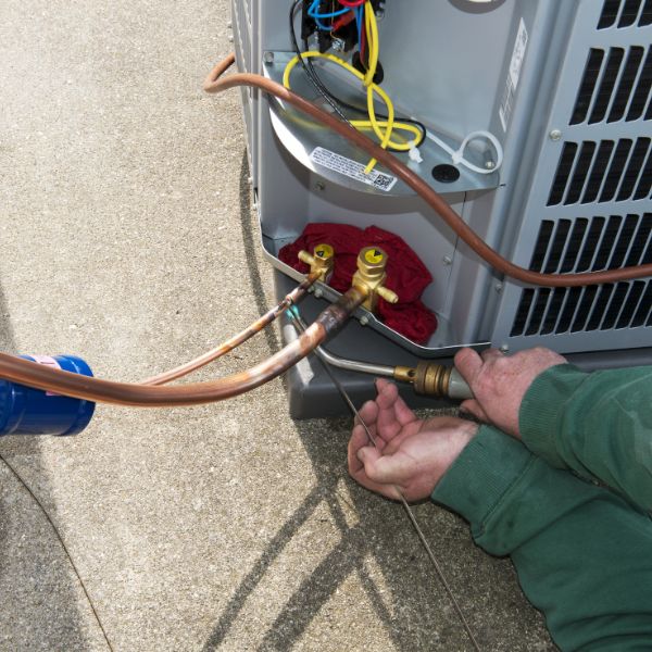 hvac technician repairing an ac unit