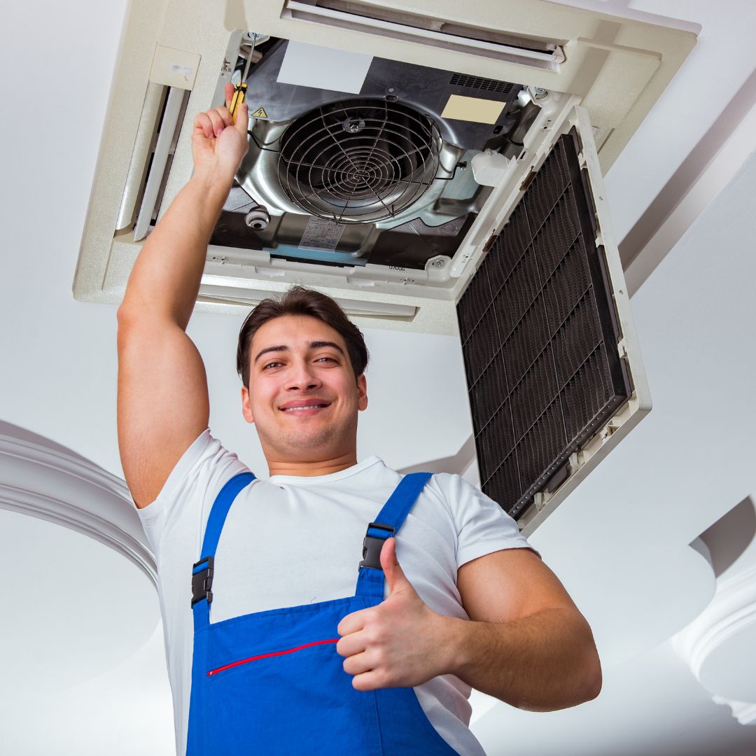 person fixing an AC