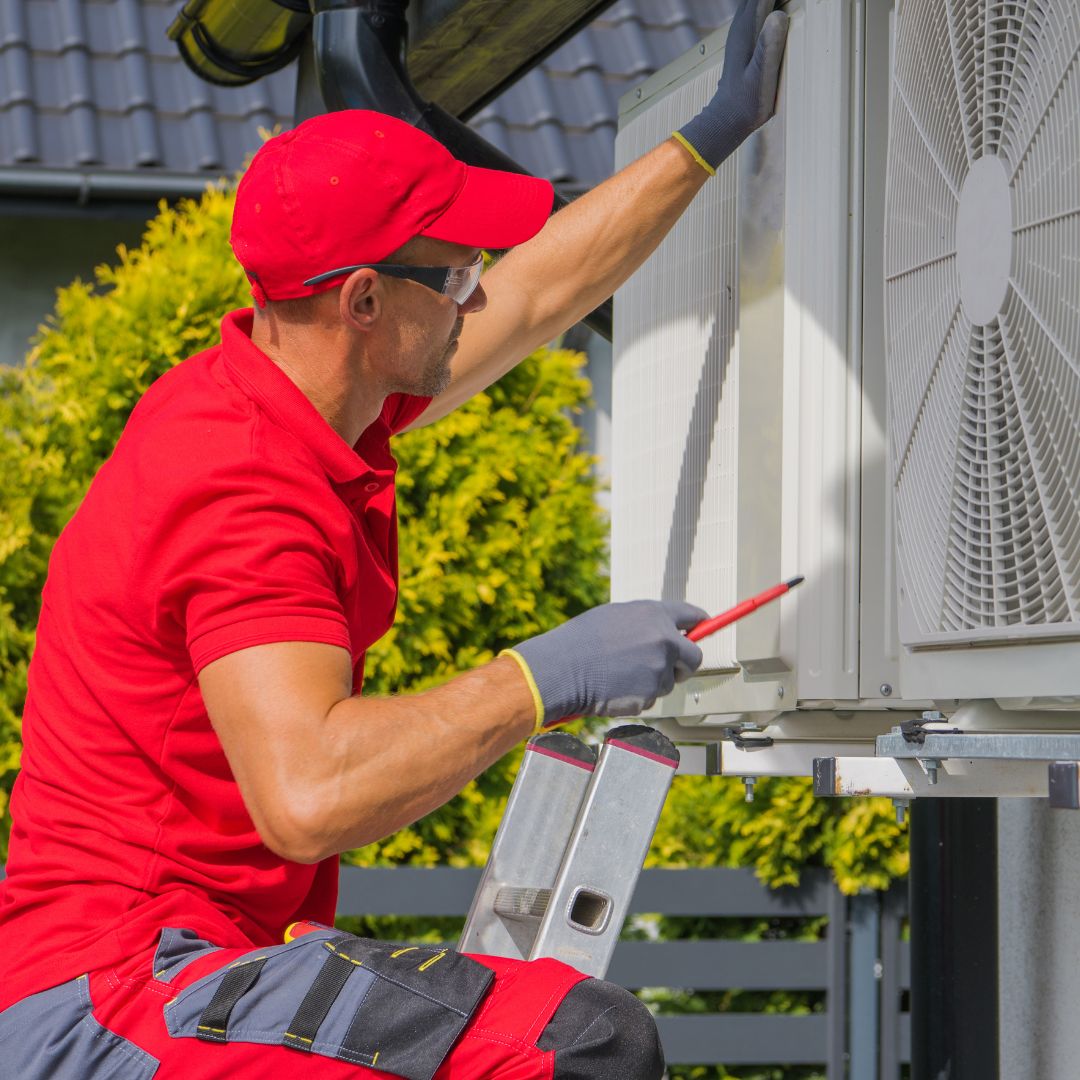 person fixing an AC